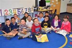 kIDS SITTING ON FLOOR SMILING